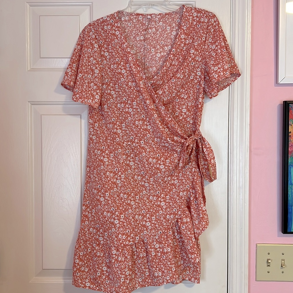 Pink wrap dress with white flowers.